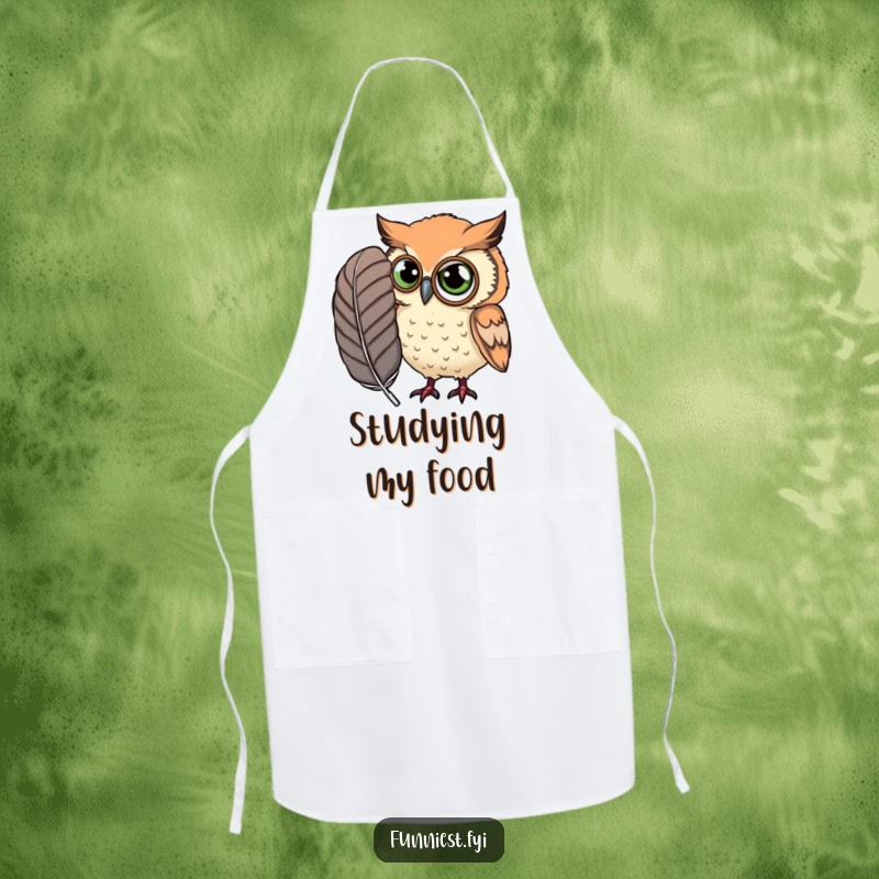 Funny Apron featuring a curious owl wearing a monocle, examining a ridiculously large feather with scholarly intent.