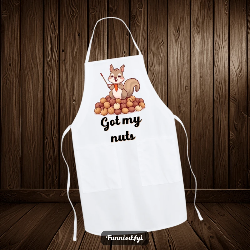 Funny Apron featuring a triumphant squirrel holding a tiny banner, standing proudly on a heap of nuts.