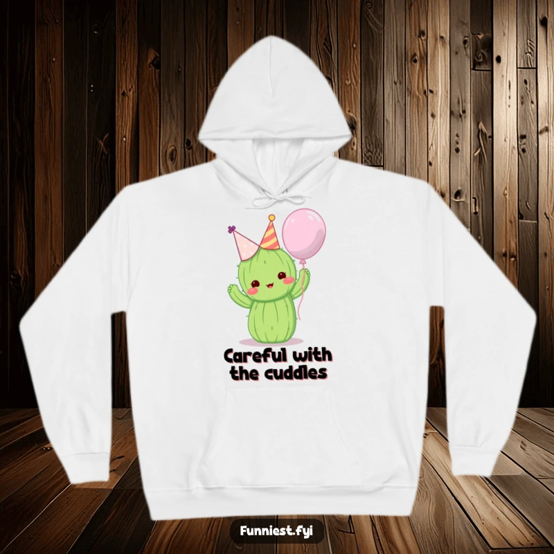 Funny hoodie with a cute cactus wearing a party hat attempting to hug a balloon, comfortable and amusing.