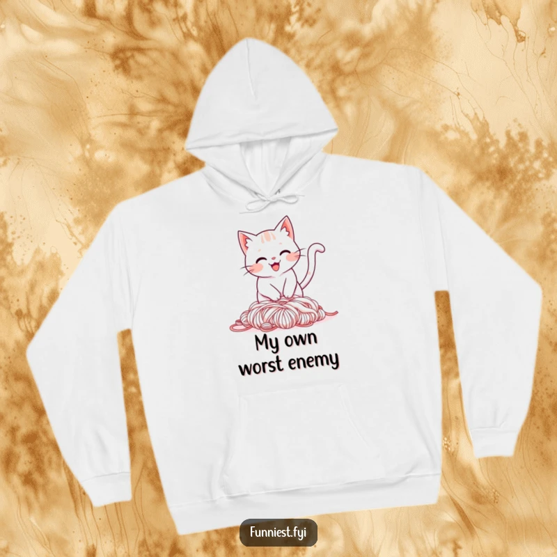 Funny hoodie depicting a smiling cat tripping over its tail into a pile of yarn, perfect for snuggly, humorous times.
