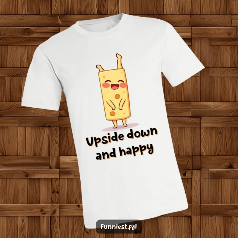 A funny, giggling cheese wedge character comically attempting a handstand, showcasing its wobbly determination on this t-shirt.