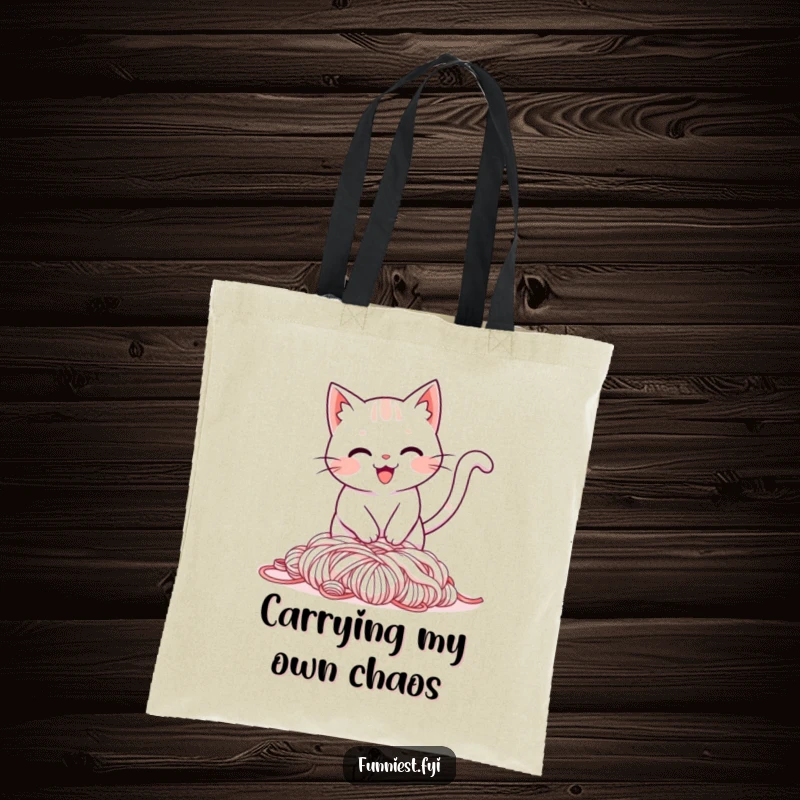 Funny tote bag illustration of a smiling cat tripping over its tail into a pile of yarn, a humorous and practical carry-all.